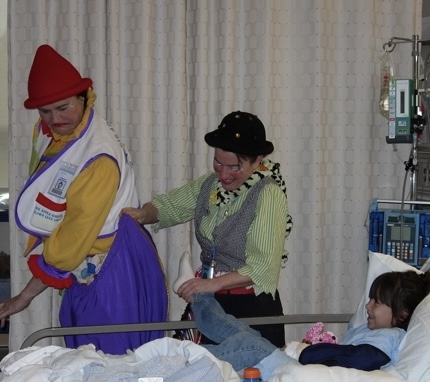 Victoria Millard as Dr. La Fou entertains a child with a fellow hospital clown