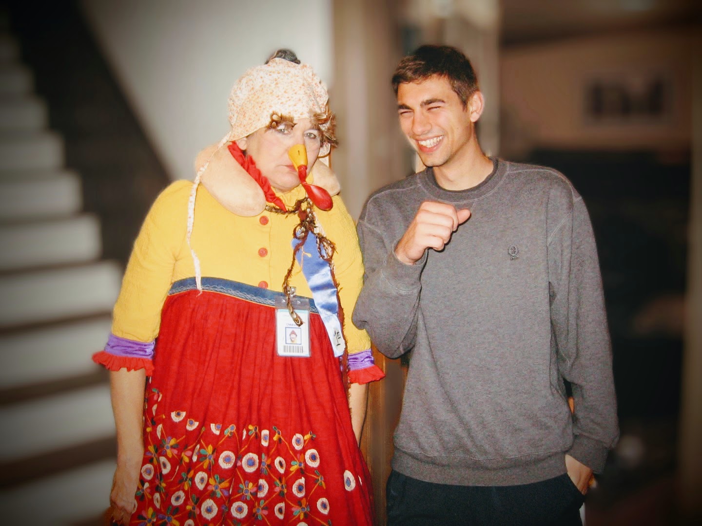 Victoria Millard frowns as a clown turkey while her son laughs