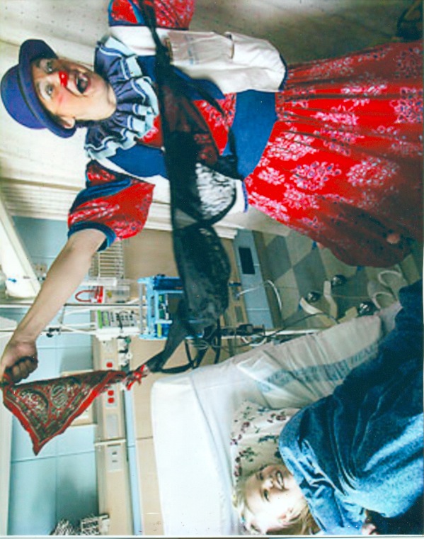 Victoria Millard as Dr. La Fou entertains a child in a hospital bed